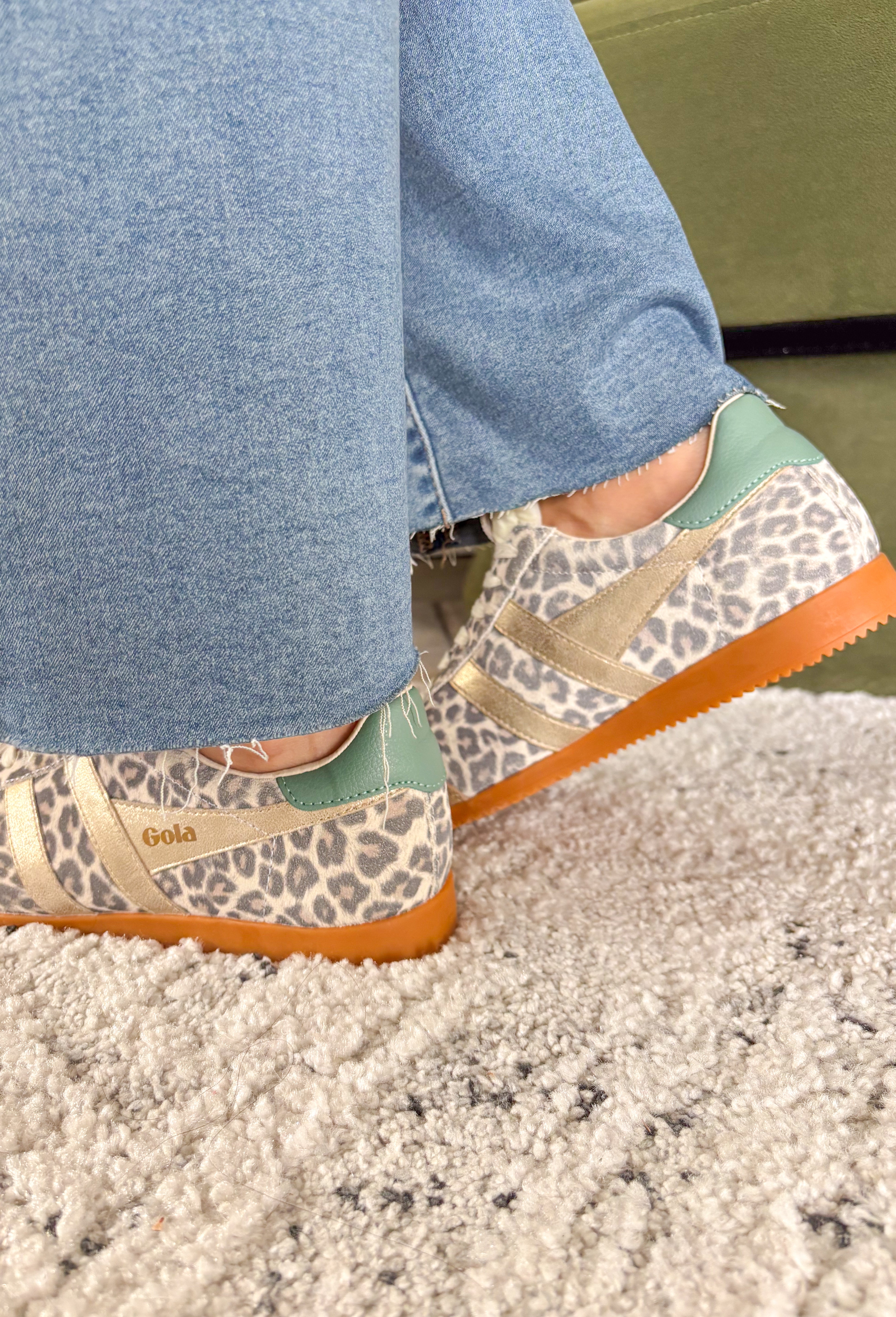 A fan favorite with a bold new twist! The Gola Elan Safari sneaker brings a fresh update to a classic silhouette with its all-over snow leopard print suede. The rich mix of caramel, gold, and green tones adds warmth and dimension, making this pair a standout while still feeling easy to style. Blending heritage-inspired design with a modern edge, this sneaker delivers both comfort and personality. 