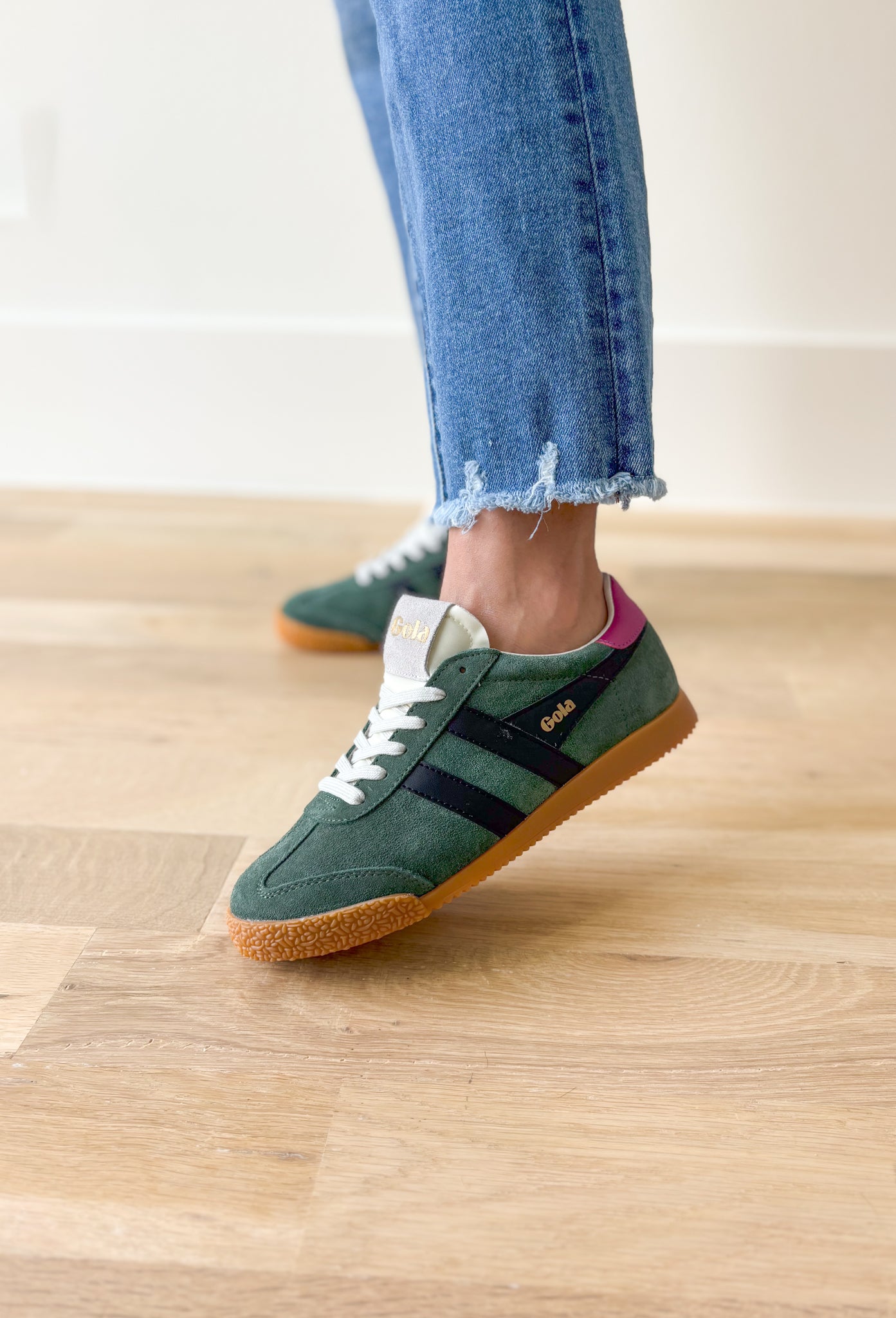 Gola Elan Sneakers in Evergreen, Evergreen samba style sneaker with black stripes, gum sole, white tongue and laces, Fuchsia back tab with gold "gola"