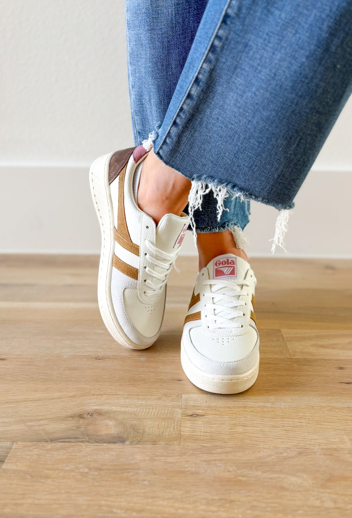 Gola Grandslam Trident Sneakers in Brown Sugar, white sneaker with cognac stripes on the side, light grey suede around the toe, mocha on the heel, faded mauve on the top of the heel