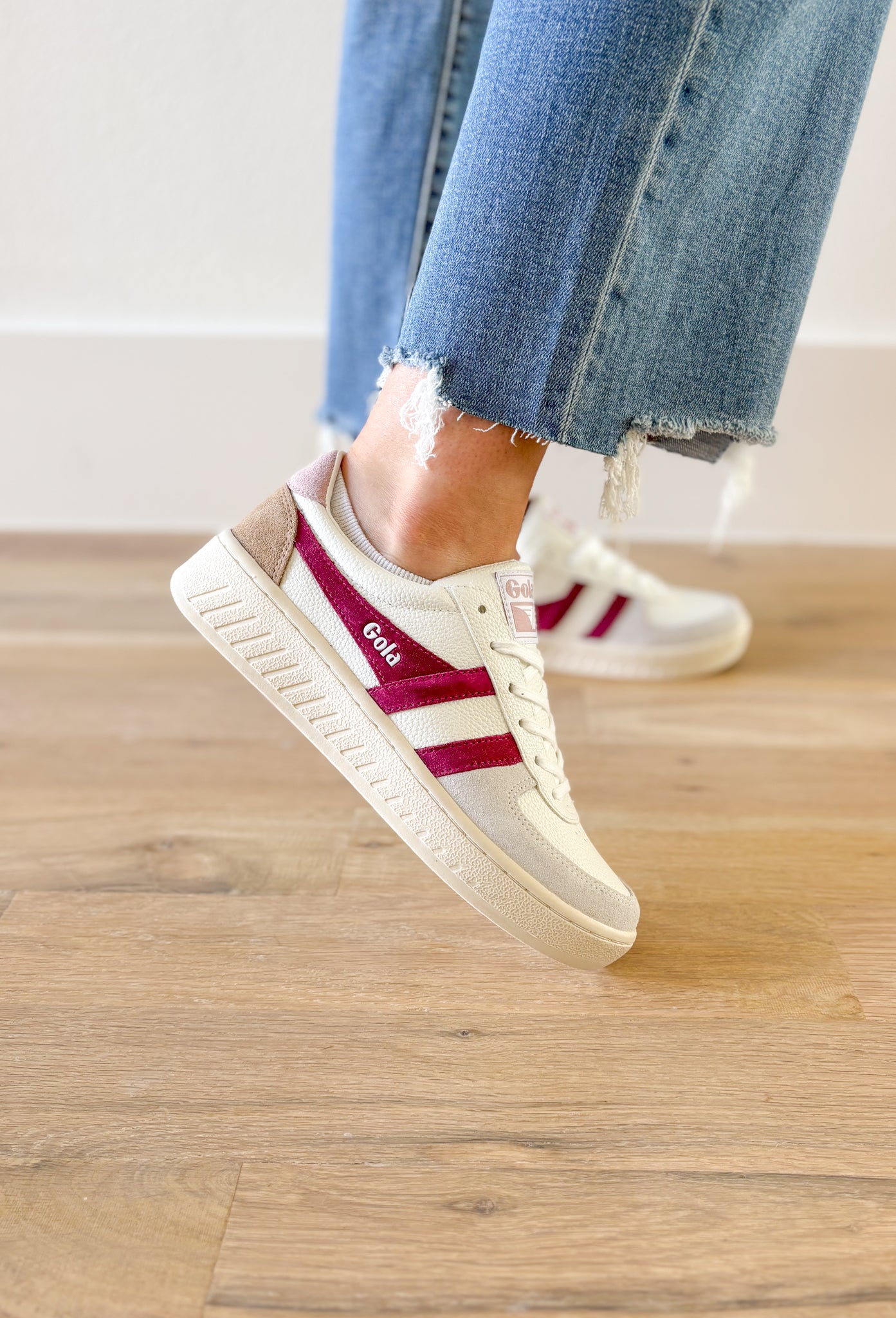 Gola Grandslam Trident Sneakers in Chalk Pink, white sneaker with light grey suede around the toe, hot fuchsia stripes, taupe on the heel, and a faded blush on the top of the heel 