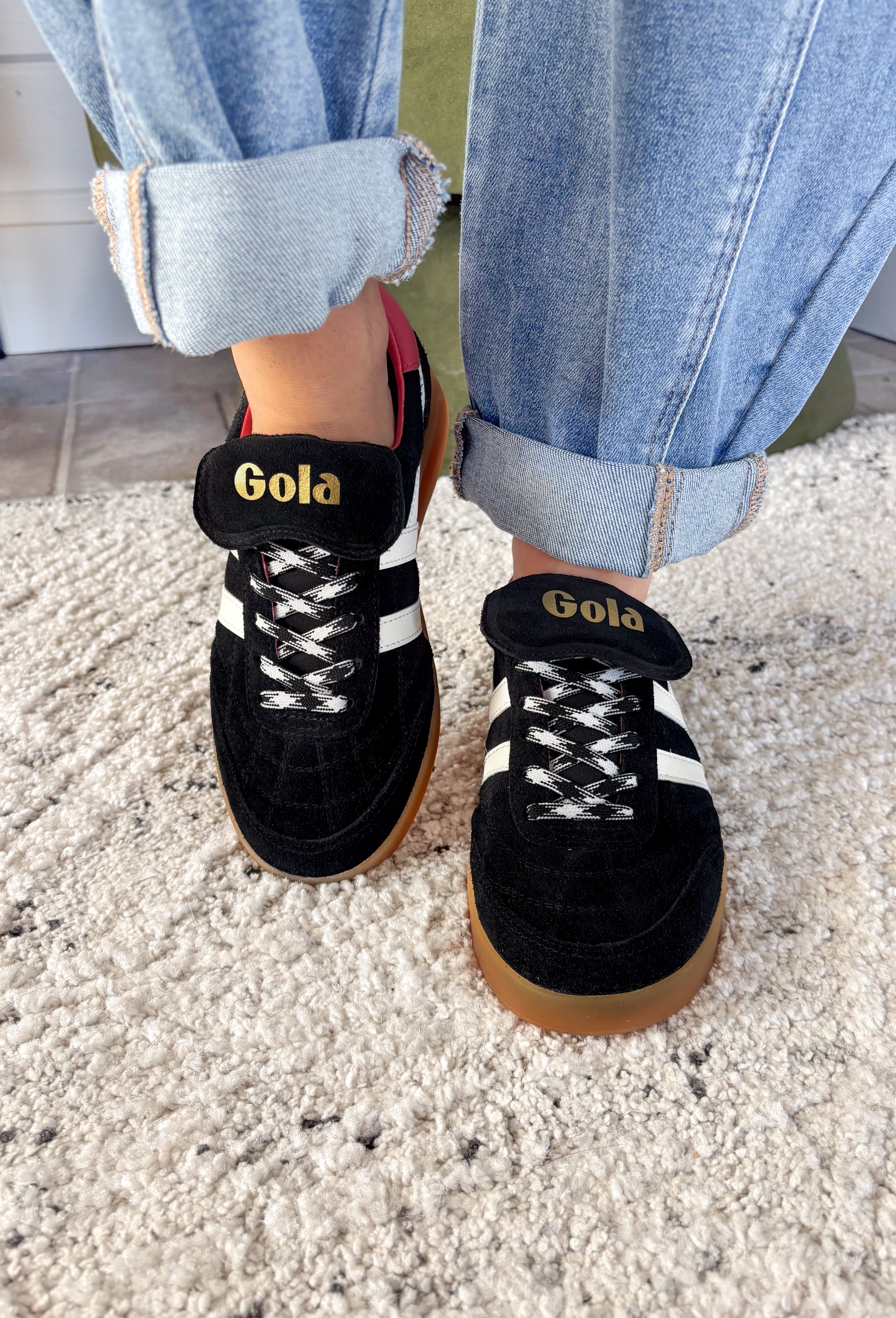 The Stadia ‘86 sneaker takes inspiration from Gola’s archives with a retro football silhouette reimagined for today. Crafted with a black suede upper, this style features check laces, a gum cup sole, and the brand’s signature off-white wingflash trim. A fold-over tongue and dark brown tab finish the design, giving it a true vintage feel with modern wearability. A standout sneaker that’s ready to bring bold, heritage style to your everyday looks.