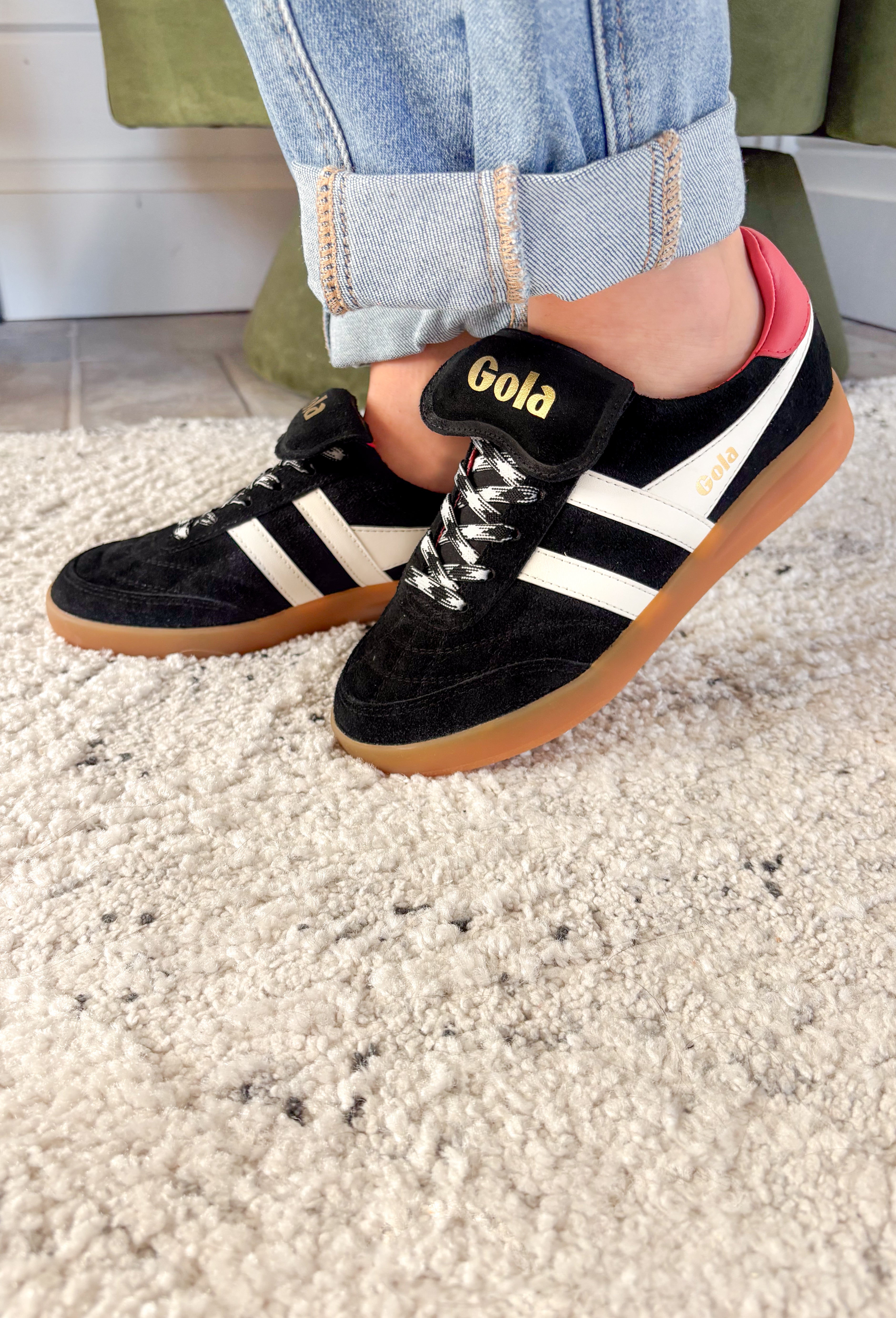 The Stadia ‘86 sneaker takes inspiration from Gola’s archives with a retro football silhouette reimagined for today. Crafted with a black suede upper, this style features check laces, a gum cup sole, and the brand’s signature off-white wingflash trim. A fold-over tongue and dark brown tab finish the design, giving it a true vintage feel with modern wearability. A standout sneaker that’s ready to bring bold, heritage style to your everyday looks.