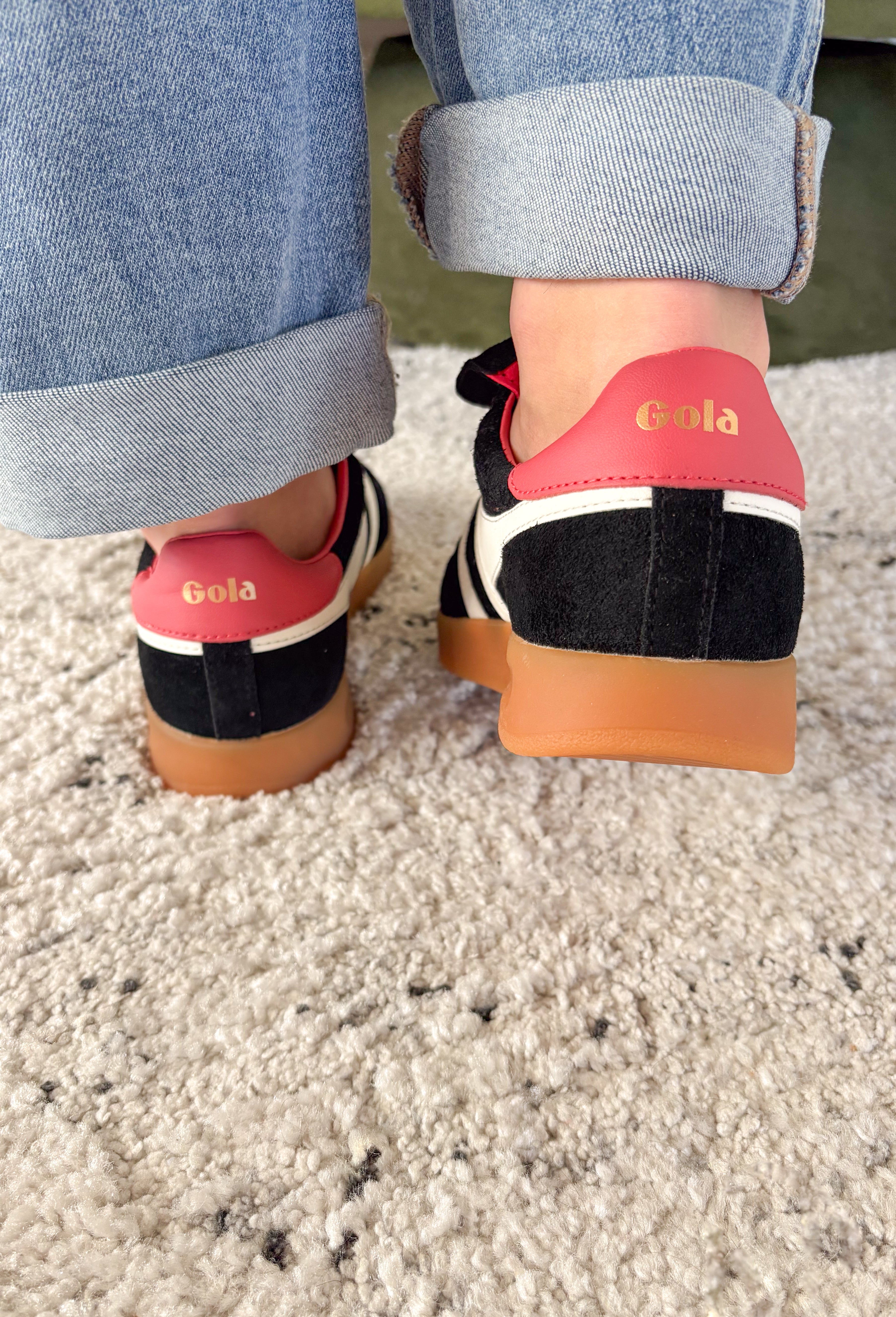 The Stadia ‘86 sneaker takes inspiration from Gola’s archives with a retro football silhouette reimagined for today. Crafted with a black suede upper, this style features check laces, a gum cup sole, and the brand’s signature off-white wingflash trim. A fold-over tongue and dark brown tab finish the design, giving it a true vintage feel with modern wearability. A standout sneaker that’s ready to bring bold, heritage style to your everyday looks.