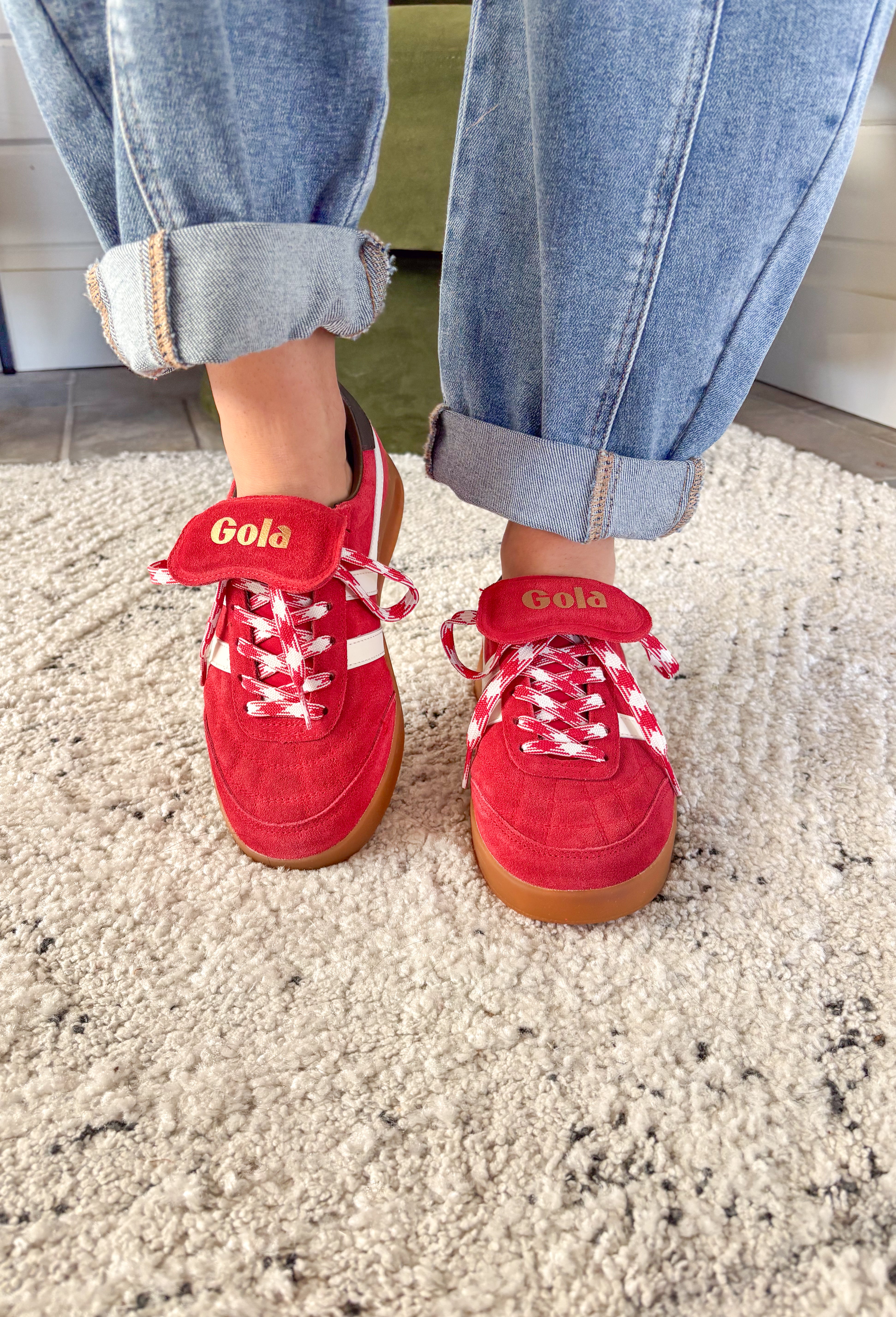 The Stadia ‘86 sneaker takes inspiration from Gola’s archives with a retro football silhouette reimagined for today. Crafted with a rich red suede upper, this style features check laces, a gum cup sole, and the brand’s signature off-white wingflash trim. A fold-over tongue and dark brown tab finish the design, giving it a true vintage feel with modern wearability. A standout sneaker that’s ready to bring bold, heritage style to your everyday looks.