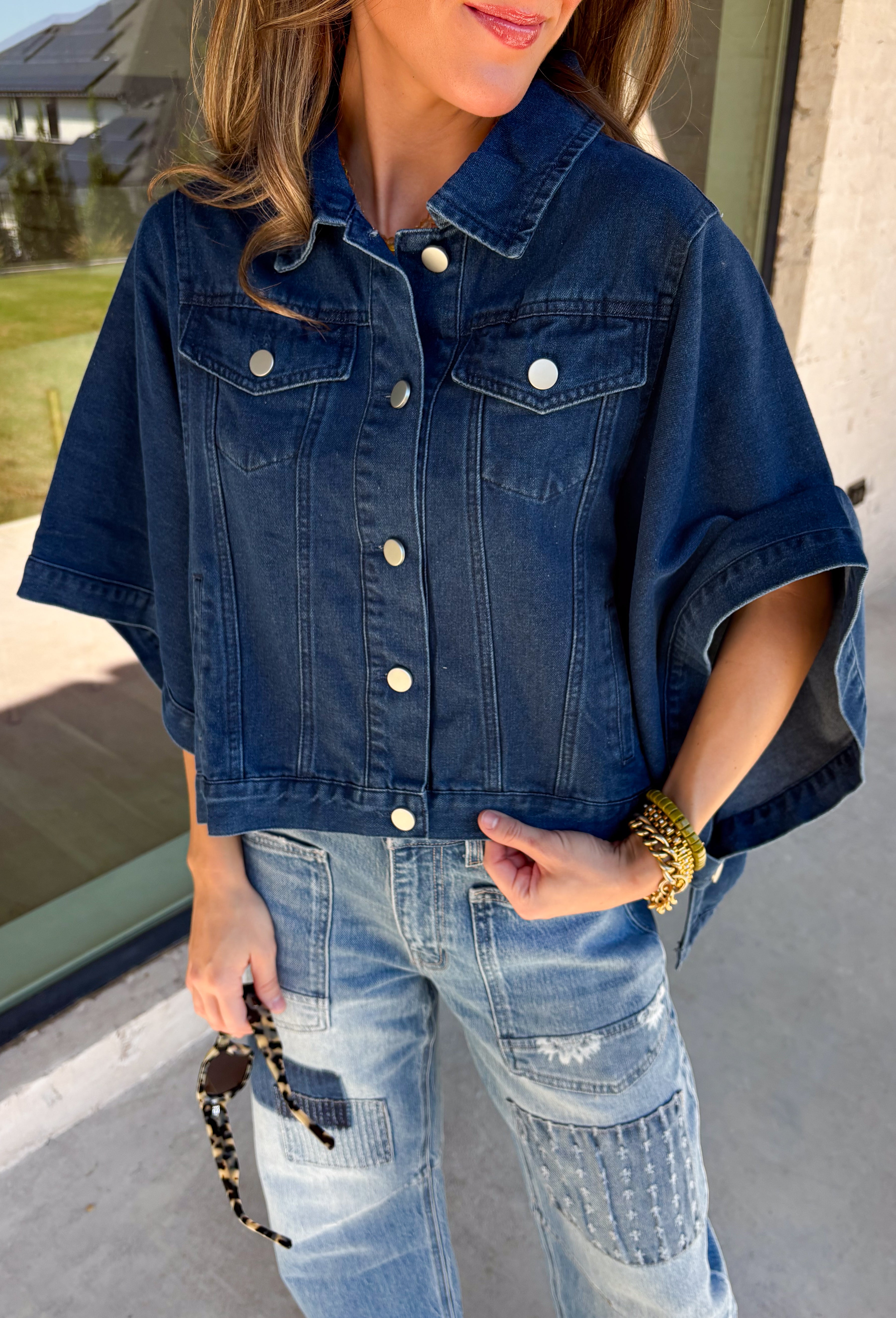 Give your everyday layers a fresh update with this dark wash denim jacket from Entro. The rich denim wash brings a classic feel to the relaxed, draped silhouette, making it an easy piece to throw on when your outfit needs a little something extra. Snap buttons down the front keep the look casual, while chest pockets and additional front pockets add functional detail. Snap button closures at the sides give the design an unexpected finishing touch while complementing its easygoing shape. 