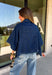 Give your everyday layers a fresh update with this dark wash denim jacket from Entro. The rich denim wash brings a classic feel to the relaxed, draped silhouette, making it an easy piece to throw on when your outfit needs a little something extra. Snap buttons down the front keep the look casual, while chest pockets and additional front pockets add functional detail. Snap button closures at the sides give the design an unexpected finishing touch while complementing its easygoing shape. 