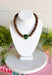 Warm, earthy color gives this beaded necklace a fun seasonal feel. Brown beads create a neutral base, while the hunter green sideways heart adds an unexpected pop of color at the front. The rich combination of brown and green makes it especially easy to pair with cozy knits, denim, and all the deeper shades of fall and winter. Wear it on its own for a simple statement or mix it into your favorite layered necklace stack.