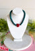 Rich seasonal color makes this beaded necklace a fun addition to your fall-to-winter jewelry lineup. Teal beads create a bold, colorful base, while the burgundy sideways heart adds a warm contrast at the front. The mix of deep teal and burgundy feels especially fitting for cooler weather and adds an easy pop of color to cozy sweaters, dresses, and holiday-season outfits. Wear it on its own for a playful statement or layer it with simple gold chains for a little extra shine.