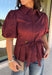 Rich burgundy and pretty shaping details make this top from Entro an easy pick for fall. The button-front design keeps the look classic, while a pleated waist and self-tie detail create a flattering shape that gives the silhouette a little something extra. Short puff sleeves add soft volume and balance out the fitted waist beautifully. Made from a cotton-blend fabric with a touch of stretch, it’s comfortable enough for all-day wear while still looking put together. 
