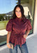 Rich burgundy and pretty shaping details make this top from Entro an easy pick for fall. The button-front design keeps the look classic, while a pleated waist and self-tie detail create a flattering shape that gives the silhouette a little something extra. Short puff sleeves add soft volume and balance out the fitted waist beautifully. Made from a cotton-blend fabric with a touch of stretch, it’s comfortable enough for all-day wear while still looking put together. 