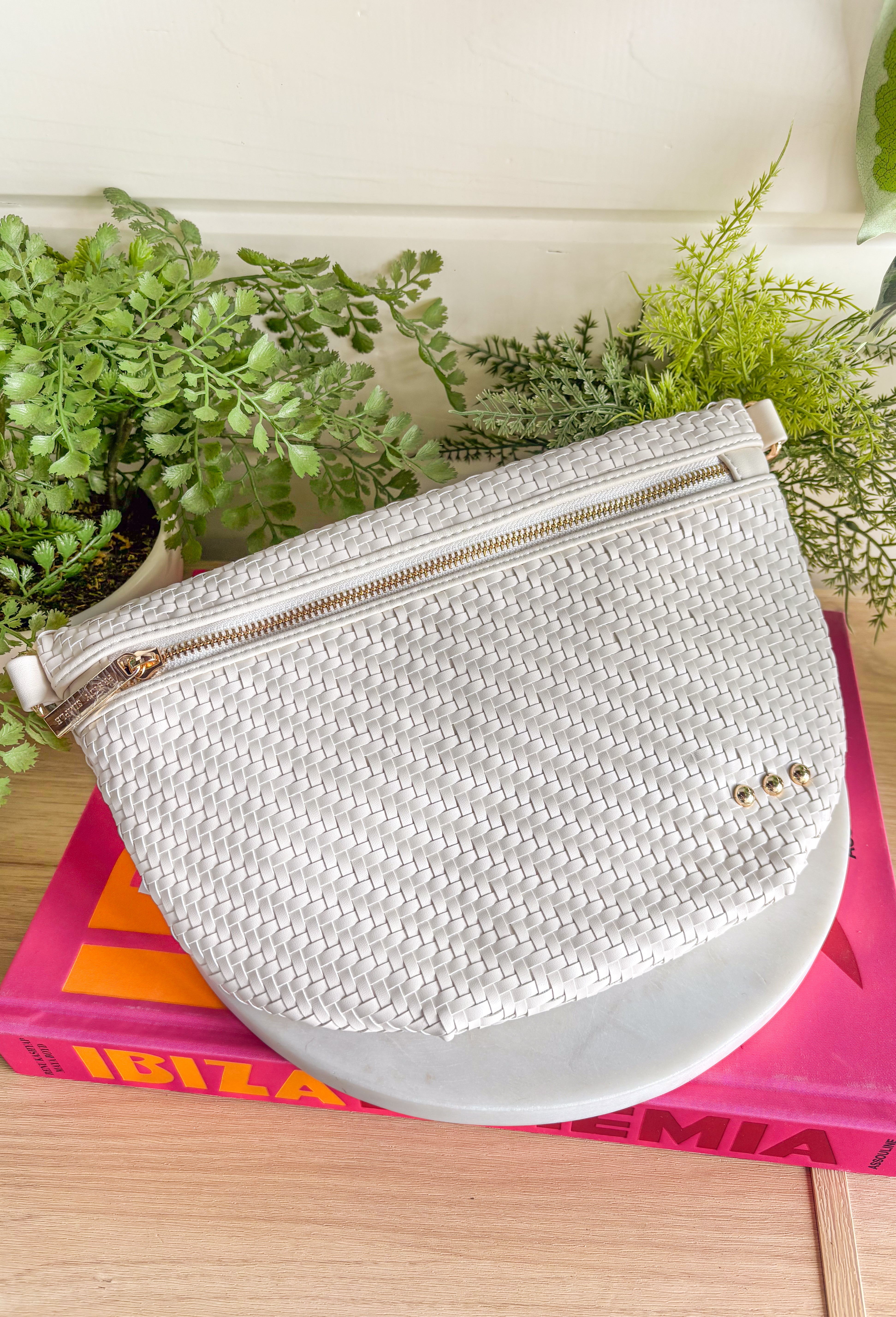 Meet your favorite Westlyn Woven Bum Bag in a new style! Gorgeous diagonal woven design makes this perfect for any occasion! Beautiful hardware with a zipper closure with "Pretty Simple" interior, and a zippered slash pocket on the inside. This crossbody bag is the perfect accessory to elevate any outfit!