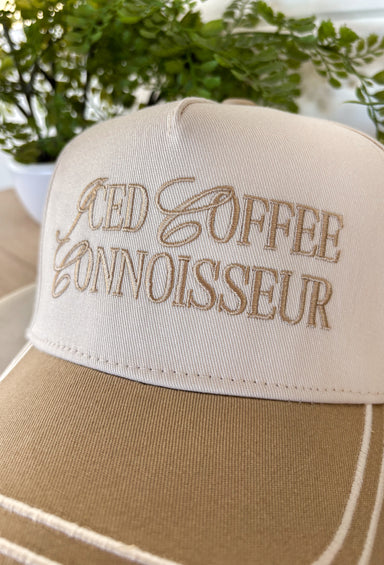 This neutral trucker hat with tan accents is a must-have for all the iced coffee lovers out there. Featuring “Iced Coffee Connoisseur” embroidered across the front, it adds a fun, laid-back touch to your everyday outfits. The neutral color palette keeps it easy to style, while the adjustable back offers a comfortable, custom fit for all-day wear. Perfect for coffee runs, casual days, and sunny spring outings, this hat is equal parts playful and practical.