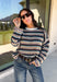Wrap yourself in the colors of the season with this cozy open knit sweater from Hyfve. Featuring a beautiful stripe pattern in cream, tan, light blue, burgundy, hunter green, and dark blue, this timeless knit captures everything you love about fall. The lightweight open knit construction makes it perfect for layering on crisp mornings and cool evenings, while the relaxed silhouette keeps it effortlessly comfortable. 
