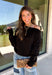 A timeless black sweater is a wardrobe essential, and this classic knit from Double Zero is one you'll wear season after season. Designed with an elegant boat neckline, this versatile sweater offers an effortlessly polished look that's easy to dress up or down. The soft knit fabric provides all-day comfort, while the ribbed hem and cuffs add a refined finishing touch. 