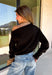 A timeless black sweater is a wardrobe essential, and this classic knit from Double Zero is one you'll wear season after season. Designed with an elegant boat neckline, this versatile sweater offers an effortlessly polished look that's easy to dress up or down. The soft knit fabric provides all-day comfort, while the ribbed hem and cuffs add a refined finishing touch. 