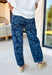 These dark wash barrel jeans bring a fresh, modern twist to everyday denim with a subtle monochromatic floral print woven throughout. The medium wash floral design adds just enough texture and interest while keeping the look sleek and easy to style. Finished with a tie detail at the waist, these jeans offer an adjustable, comfortable fit that still feels polished. The barrel-leg silhouette gives them that relaxed, on-trend shape that pairs perfectly with everything from fitted tees to flowy spring tops.