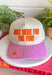 Bring a little extra fun wherever you go with this playful trucker hat! Featuring "Just Here For The Fun" embroidered in bright orange, this hat is made for football Saturdays, fall festivals, road trips, and spontaneous adventures. The pink bill with neutral stripes adds the perfect pop of color, while the light pink and orange embroidered stars give it a cheerful finishing touch. 