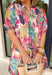 Soft, flowy, and full of spring color, this short sleeve dress by Umgee is a total breath of fresh air. Featuring a watercolor-inspired abstract floral print in shades of pink, blue, green, purple, and off white, this dress feels light and dreamy for the season. Smocking along the top creates a flattering, comfortable fit, while the front tie detail, elastic sleeves, and tiered skirt add movement and charm. Fully lined and made from breathable tencel