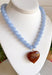 Fun, playful, and full of personality! This necklace features light blue beading paired with a brown heart pendant for the perfect touch of contrast. Lightweight and easy to style, this necklace looks just as cute worn on its own as it does layered with your favorite chains and beaded pieces. It’s the perfect finishing touch for adding a subtle pop of color to your everyday outfits.