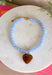 Fun, playful, and full of personality! This necklace features light blue beading paired with a brown heart pendant for the perfect touch of contrast. Lightweight and easy to style, this necklace looks just as cute worn on its own as it does layered with your favorite chains and beaded pieces. It’s the perfect finishing touch for adding a subtle pop of color to your everyday outfits.