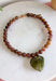 Fun, playful, and full of personality. This necklace features brown beading paired with a olive heart pendant for the perfect touch of contrast. Lightweight and easy to style, this necklace looks just as cute worn on its own as it does layered with your favorite chains and beaded pieces. It’s the perfect finishing touch for adding a subtle pop of color to your everyday outfits.