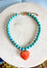Bright, playful, and full of personality! This turquoise beaded necklace features a vibrant orange heart pendant that adds the perfect pop of color. The combination of the cool turquoise beads and the bold heart charm creates a fun, eye-catching look that instantly brightens any outfit. Lightweight and easy to style, this necklace looks just as cute worn on its own as it does layered with your favorite chains and beaded pieces. 