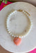 Sweet, playful, and full of charm! This white beaded necklace features a light pink heart pendant that adds the perfect soft pop of color. The combination of crisp white beads and the blush heart charm creates a fresh, feminine look that’s easy to style for everyday wear. Lightweight and easy to layer, this necklace looks just as cute worn on its own as it does stacked with your favorite gold or beaded pieces. It’s a simple way to add a little love and personality to any outfit.