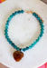 Fun, playful, and full of personality!&nbsp;This necklace features teal beading paired with a brown heart pendant for the perfect touch of contrast. Lightweight and easy to style, this necklace looks just as cute worn on its own as it does layered with your favorite chains and beaded pieces. It’s the perfect finishing touch for adding a subtle pop of color to your everyday outfits.