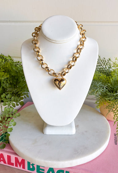 A classic heart gets a bold update with this chunky gold chain necklace. The statement-making chain is finished with a gold heart pendant, creating a simple but eye-catching look that’s easy to wear with just about anything. The shorter length makes it perfect for showing off with sweaters, blouses, and dresses while adding plenty of shine around the neckline. Wear it on its own as your statement piece or mix it into a layered necklace stack for a little extra gold.