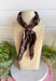 Add an easy western-inspired touch to your outfit with this brown bandana neck scarf. The rich brown color makes it a versatile accessory for fall while the soft material keeps it comfortable enough to wear all day long. Tie it around your neck for a classic bandana look, wear it as a headband, or knot it onto your favorite handbag for a fun pop of personality. From gameday and concerts to weekend plans and fall outings, there are plenty of ways to make this scarf your own.