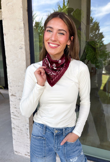 Add an easy western-inspired touch to your outfit with this burgundy bandana neck scarf. The bold burgundy color makes it a versatile accessory for fall while the soft material keeps it comfortable enough to wear all day long. Tie it around your neck for a classic bandana look, wear it as a headband, or knot it onto your favorite handbag for a fun pop of personality. From gameday and concerts to weekend plans and fall outings, there are plenty of ways to make this scarf your own.