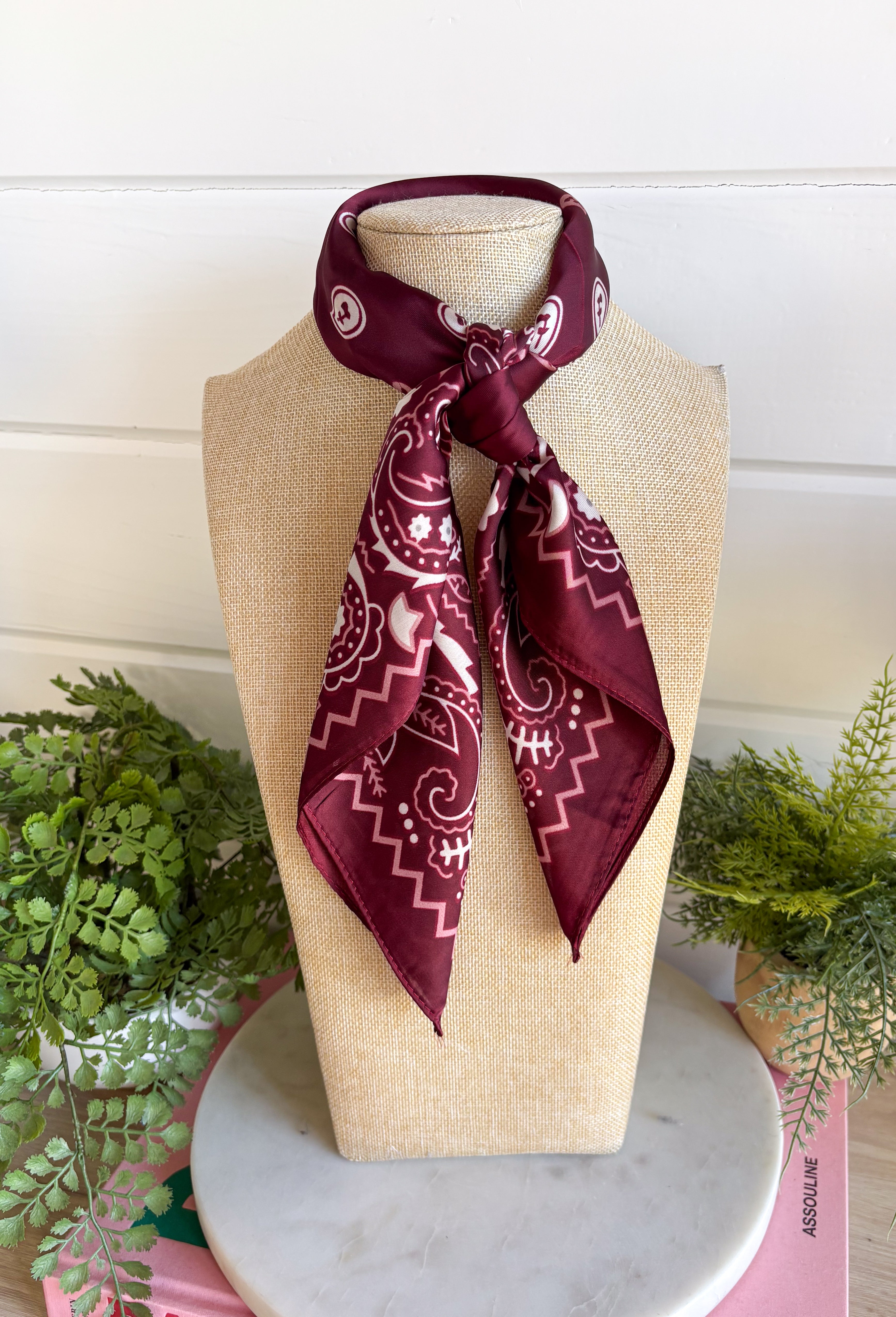 Add an easy western-inspired touch to your outfit with this burgundy bandana neck scarf. The bold burgundy color makes it a versatile accessory for fall while the soft material keeps it comfortable enough to wear all day long. Tie it around your neck for a classic bandana look, wear it as a headband, or knot it onto your favorite handbag for a fun pop of personality. From gameday and concerts to weekend plans and fall outings, there are plenty of ways to make this scarf your own.