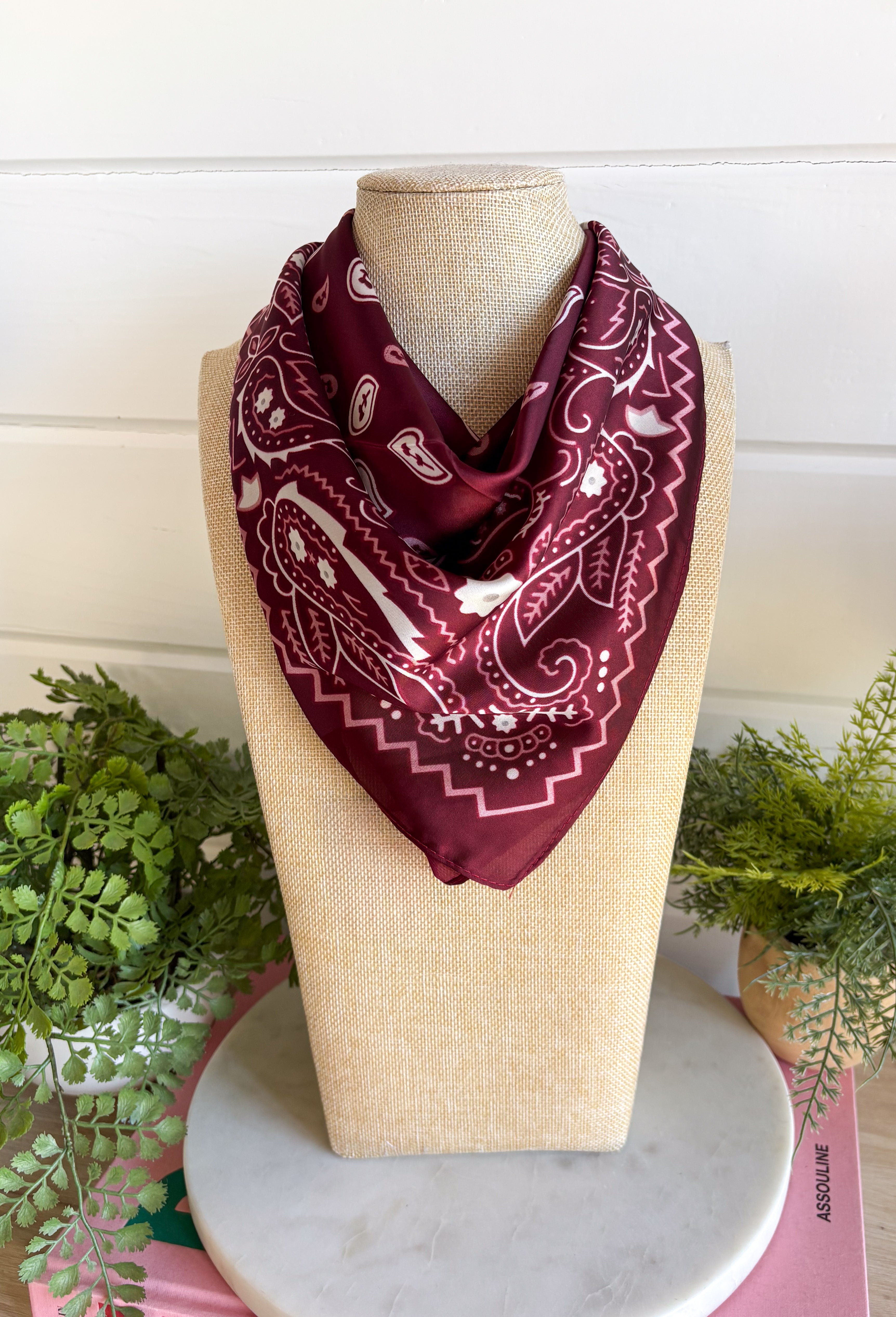 Add an easy western-inspired touch to your outfit with this burgundy bandana neck scarf. The bold burgundy color makes it a versatile accessory for fall while the soft material keeps it comfortable enough to wear all day long. Tie it around your neck for a classic bandana look, wear it as a headband, or knot it onto your favorite handbag for a fun pop of personality. From gameday and concerts to weekend plans and fall outings, there are plenty of ways to make this scarf your own.