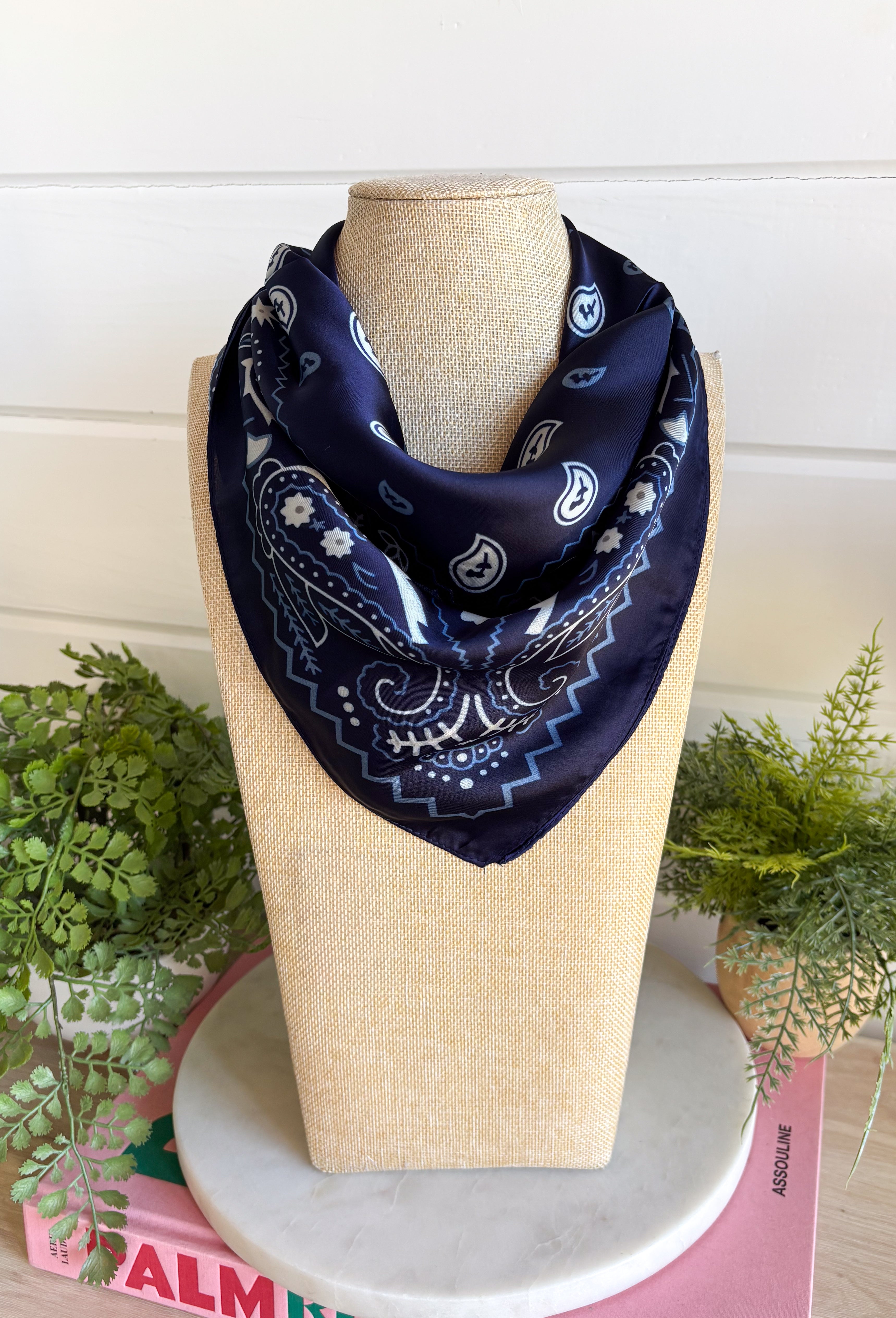 Add an easy western-inspired touch to your outfit with this navy bandana neck scarf. The rich navy color makes it a versatile accessory for fall while the soft material keeps it comfortable enough to wear all day long. Tie it around your neck for a classic bandana look, wear it as a headband, or knot it onto your favorite handbag for a fun pop of personality. From gameday and concerts to weekend plans and fall outings, there are plenty of ways to make this scarf your own.