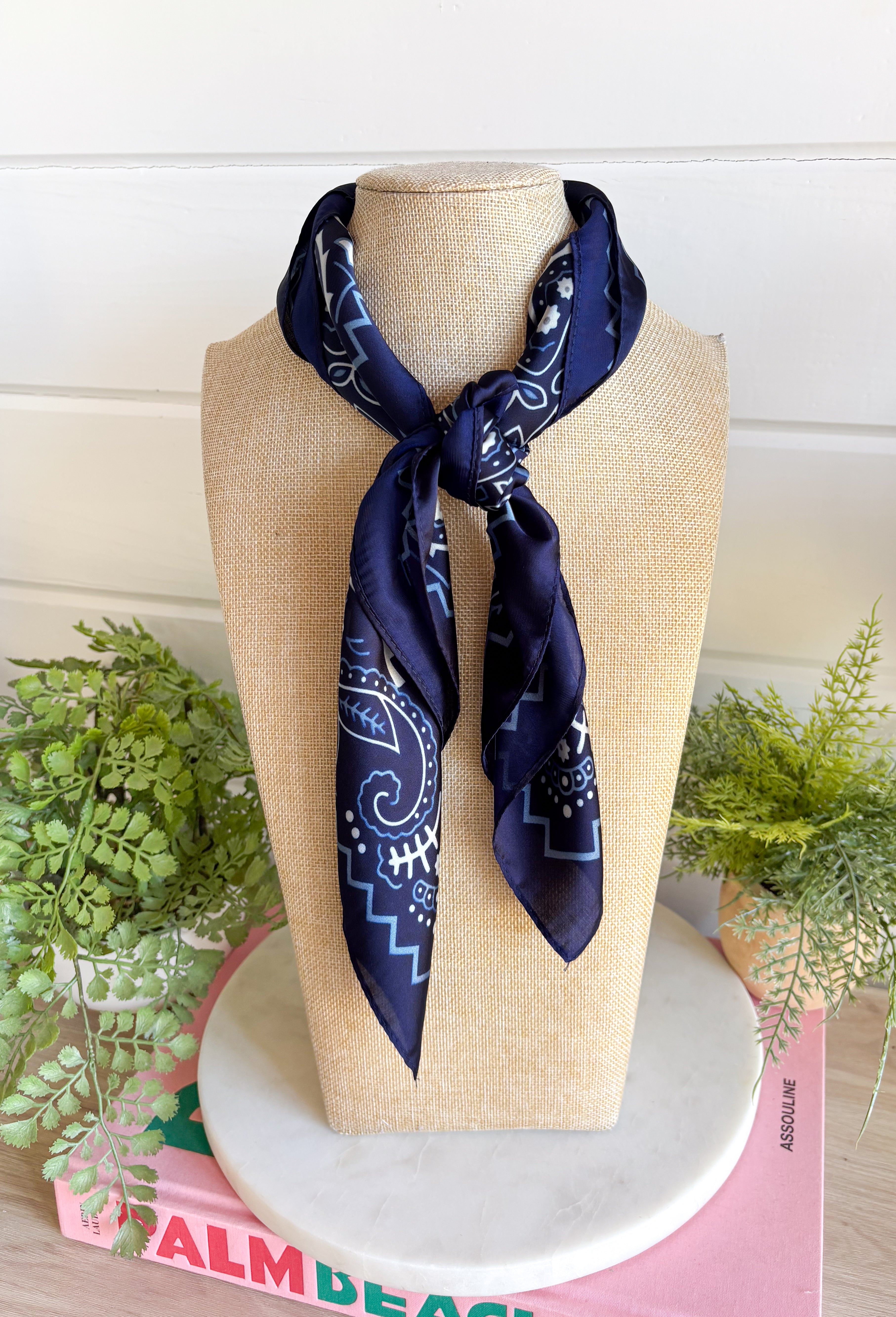 Add an easy western-inspired touch to your outfit with this navy bandana neck scarf. The rich navy color makes it a versatile accessory for fall while the soft material keeps it comfortable enough to wear all day long. Tie it around your neck for a classic bandana look, wear it as a headband, or knot it onto your favorite handbag for a fun pop of personality. From gameday and concerts to weekend plans and fall outings, there are plenty of ways to make this scarf your own.