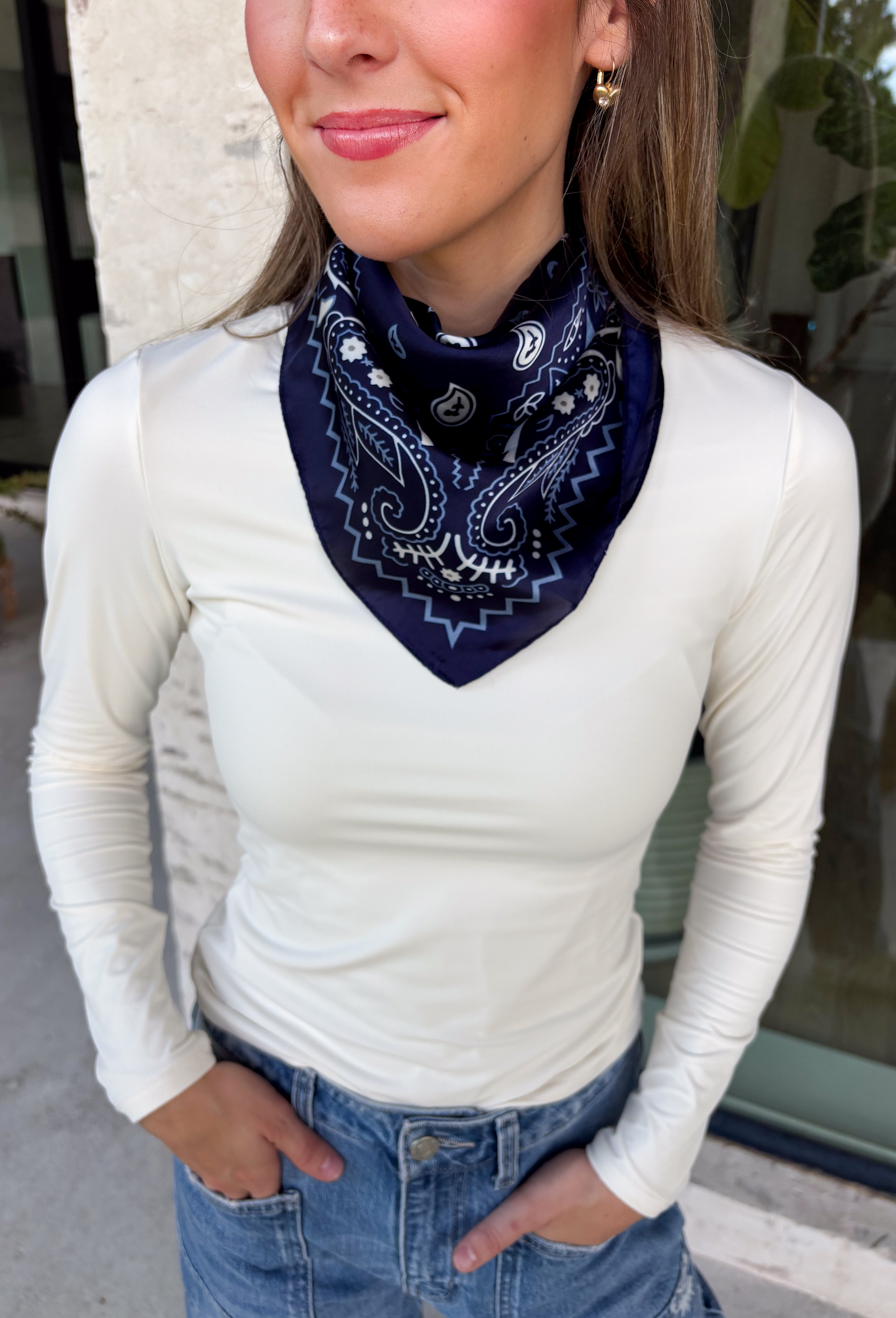 Add an easy western-inspired touch to your outfit with this navy bandana neck scarf. The rich navy color makes it a versatile accessory for fall while the soft material keeps it comfortable enough to wear all day long. Tie it around your neck for a classic bandana look, wear it as a headband, or knot it onto your favorite handbag for a fun pop of personality. From gameday and concerts to weekend plans and fall outings, there are plenty of ways to make this scarf your own.