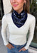 Add an easy western-inspired touch to your outfit with this navy bandana neck scarf. The rich navy color makes it a versatile accessory for fall while the soft material keeps it comfortable enough to wear all day long. Tie it around your neck for a classic bandana look, wear it as a headband, or knot it onto your favorite handbag for a fun pop of personality. From gameday and concerts to weekend plans and fall outings, there are plenty of ways to make this scarf your own.