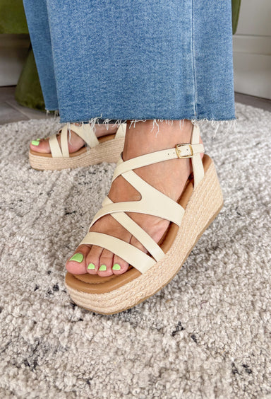Effortless, versatile, and perfect for sunny days! These neutral wedge sandals feature soft neutral straps in a flattering criss cross design that pairs with just about everything in your closet. The woven espadrille platform adds that classic warm-weather touch, giving you a little height while still feeling easy to walk in. Finished with an adjustable ankle buckle for a secure fit, these wedges are perfect for dressing up your everyday looks or adding a polished touch to your favorite dresses.