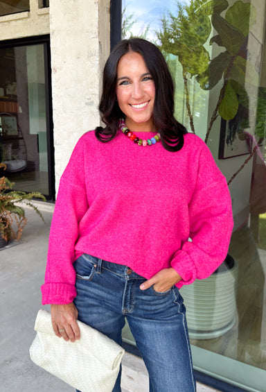 Every wardrobe needs a classic sweater you'll reach for season after season, and this cozy knit from Double Zero is just that. Designed in a bold fuchsia hue, this timeless sweater is effortlessly versatile and easy to style with all your favorite fall pieces. Ribbed detailing at the neckline, cuffs, and hem adds a polished finish, while the ultra-soft knit keeps you warm and comfortable without feeling bulky. 