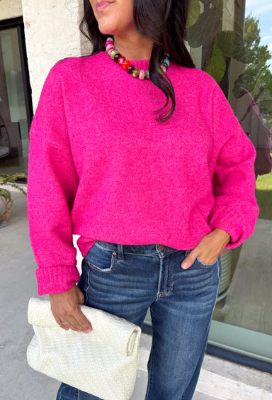 Every wardrobe needs a classic sweater you'll reach for season after season, and this cozy knit from Double Zero is just that. Designed in a bold fuchsia hue, this timeless sweater is effortlessly versatile and easy to style with all your favorite fall pieces. Ribbed detailing at the neckline, cuffs, and hem adds a polished finish, while the ultra-soft knit keeps you warm and comfortable without feeling bulky. 
