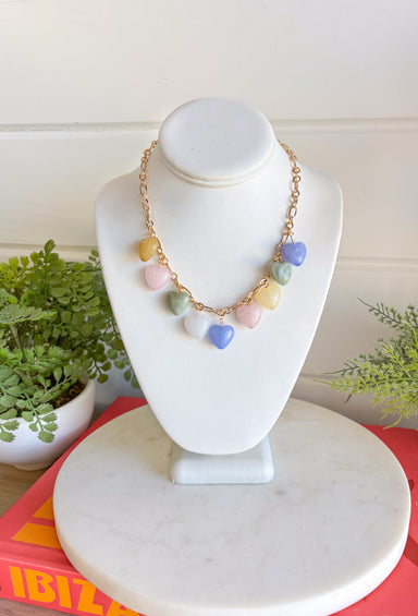 This gold chain necklace with pastel heart charms is the sweetest little addition to your spring jewelry lineup! It brings a soft pop of color while still feeling light, dainty, and easy to wear every day. The delicate chain makes it perfect for layering, while the playful heart details add just enough charm to elevate your favorite tees, dresses, and lightweight knits. Don’t miss out—this one’s made for everyday wear!