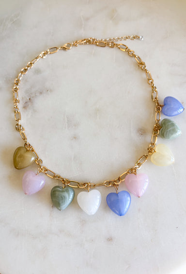 This gold chain necklace with pastel heart charms is the sweetest little addition to your spring jewelry lineup! It brings a soft pop of color while still feeling light, dainty, and easy to wear every day. The delicate chain makes it perfect for layering, while the playful heart details add just enough charm to elevate your favorite tees, dresses, and lightweight knits. Don’t miss out—this one’s made for everyday wear!