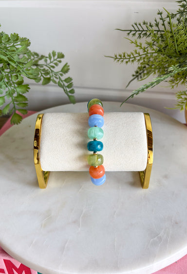 Add a playful pop of color to your everyday stack with this beaded bracelet from Garden Party. Shades of blue, orange, and green create a bright mix, while small gold beads in between add just the right touch of shine. The pull-on design makes it easy to slip on and go, whether you’re wearing it solo or mixing it with your favorite bracelets. It’s a fun little accessory for bringing extra color and personality to even the simplest outfit.