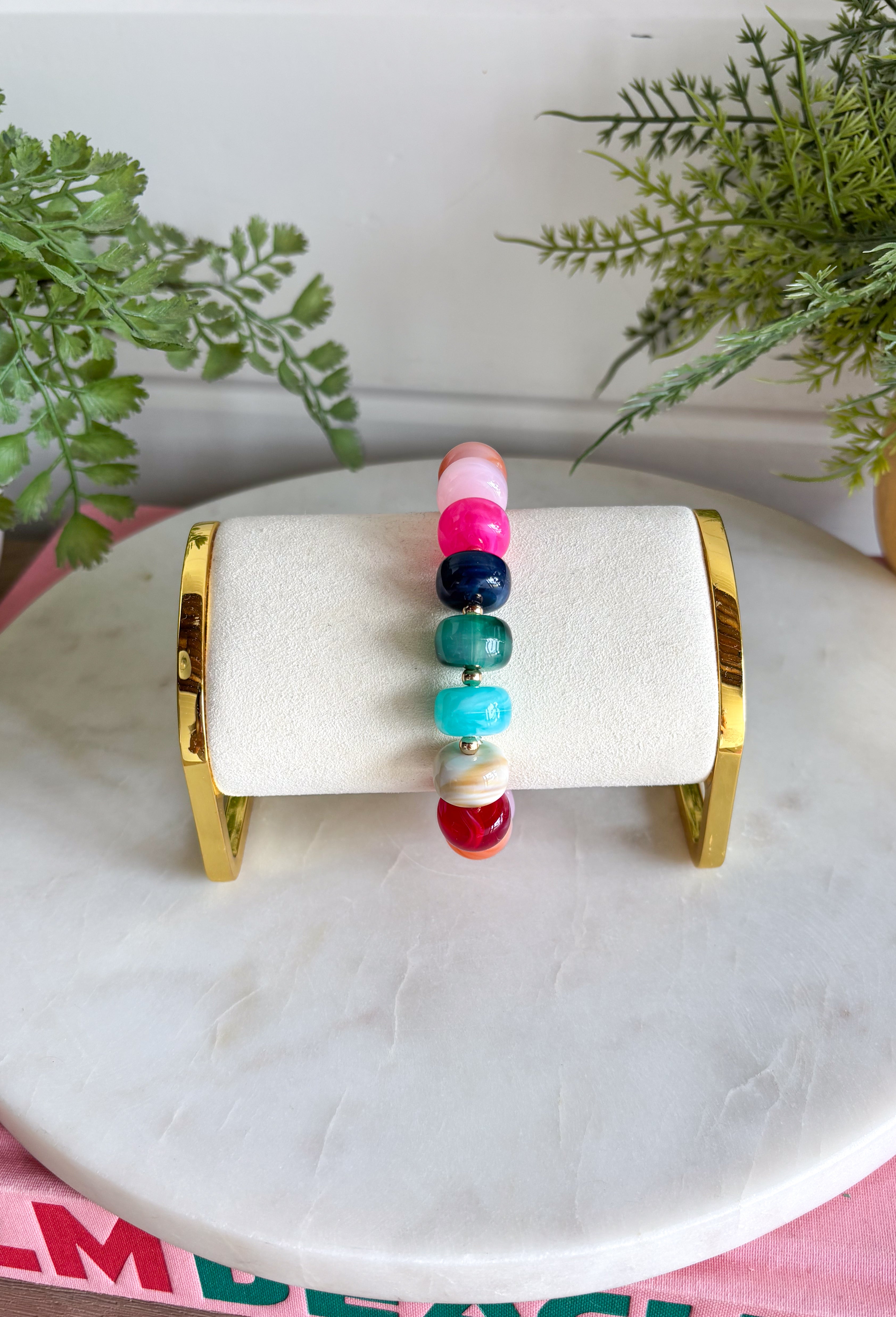 Add a playful pop of color to your everyday stack with this beaded bracelet from Garden Party. A cheerful mix of pink, burgundy, orange, blue, and green beads creates a colorful statement, while small gold beads in between each add just the right amount of shine. The pull-on design makes it easy to slip on and go, whether you wear it by itself or mix it into your favorite bracelet stack. It’s an easy way to bring a little extra color and personality to everything from cozy sweaters to everyday denim.