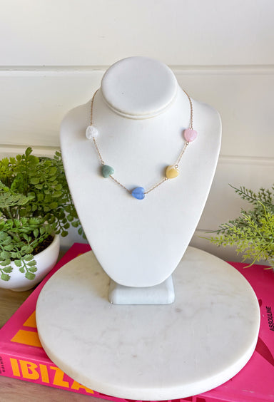 Girl, this dainty gold chain necklace with pastel heart charms is giving all the sweet spring vibes! It’s the perfect everyday necklace to add a soft pop of color while still keeping things simple and chic. Lightweight and easy to layer, this cutie pairs effortlessly with your favorite tees, dresses, or even a cozy knit for those breezy spring mornings. Whether you're heading to brunch, carpool, or date night, this piece adds just the right touch of charm.