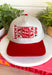 Feeling lucky? This trucker hat is the perfect blend of playful and classic, featuring "Lucky You" embroidered in red alongside a detailed playing card design on the front. The neutral crown and bold red bill create an eye-catching contrast that's easy to style for everyday wear. With its fun, casino-inspired graphic and adjustable fit, it's the perfect accessory for game nights, weekend outings, concerts, or simply adding a little personality to your look.