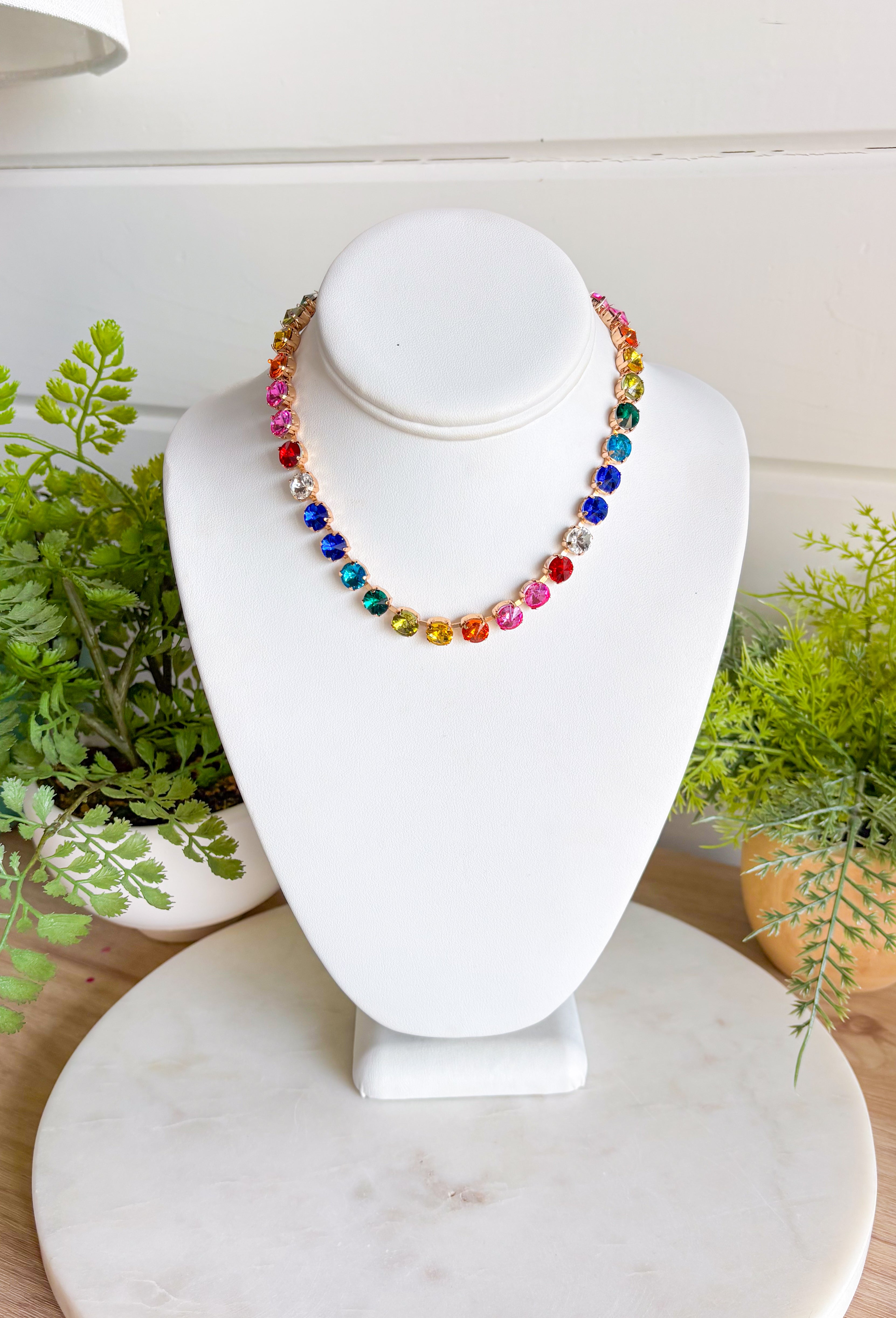This vibrant rainbow gemstone necklace is pure spring joy in accessory form. Featuring faceted crystal stones in bold, playful colors, each gem is set in a warm gold setting that adds just the right touch of polish. The mix of colors makes it an instant outfit-lifter—perfect for adding personality to everyday looks or finishing off a fun spring outfit. Wear it solo as a statement or layer it with your favorite gold chains for an easy, colorful moment.