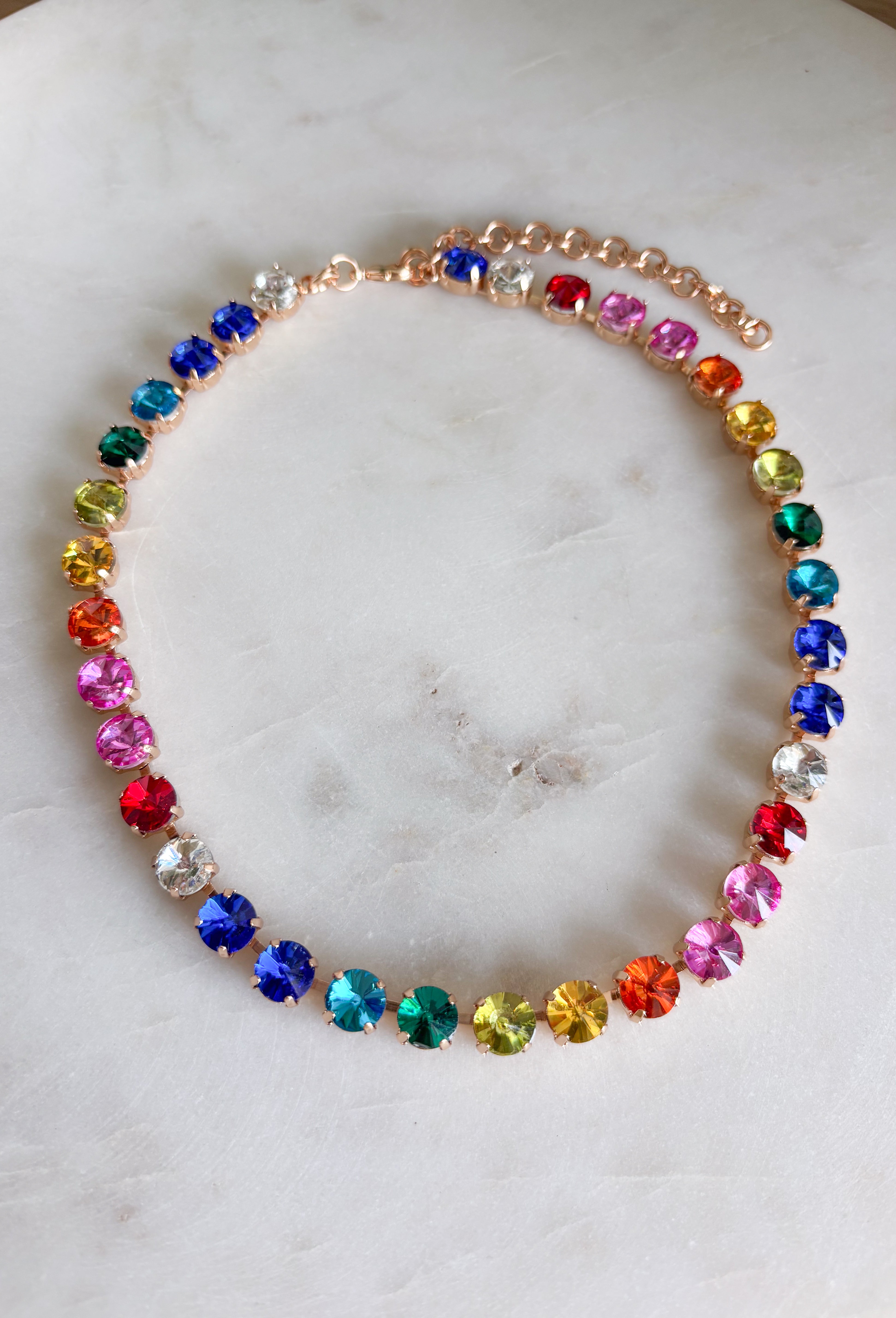 This vibrant rainbow gemstone necklace is pure spring joy in accessory form. Featuring faceted crystal stones in bold, playful colors, each gem is set in a warm gold setting that adds just the right touch of polish. The mix of colors makes it an instant outfit-lifter—perfect for adding personality to everyday looks or finishing off a fun spring outfit. Wear it solo as a statement or layer it with your favorite gold chains for an easy, colorful moment.