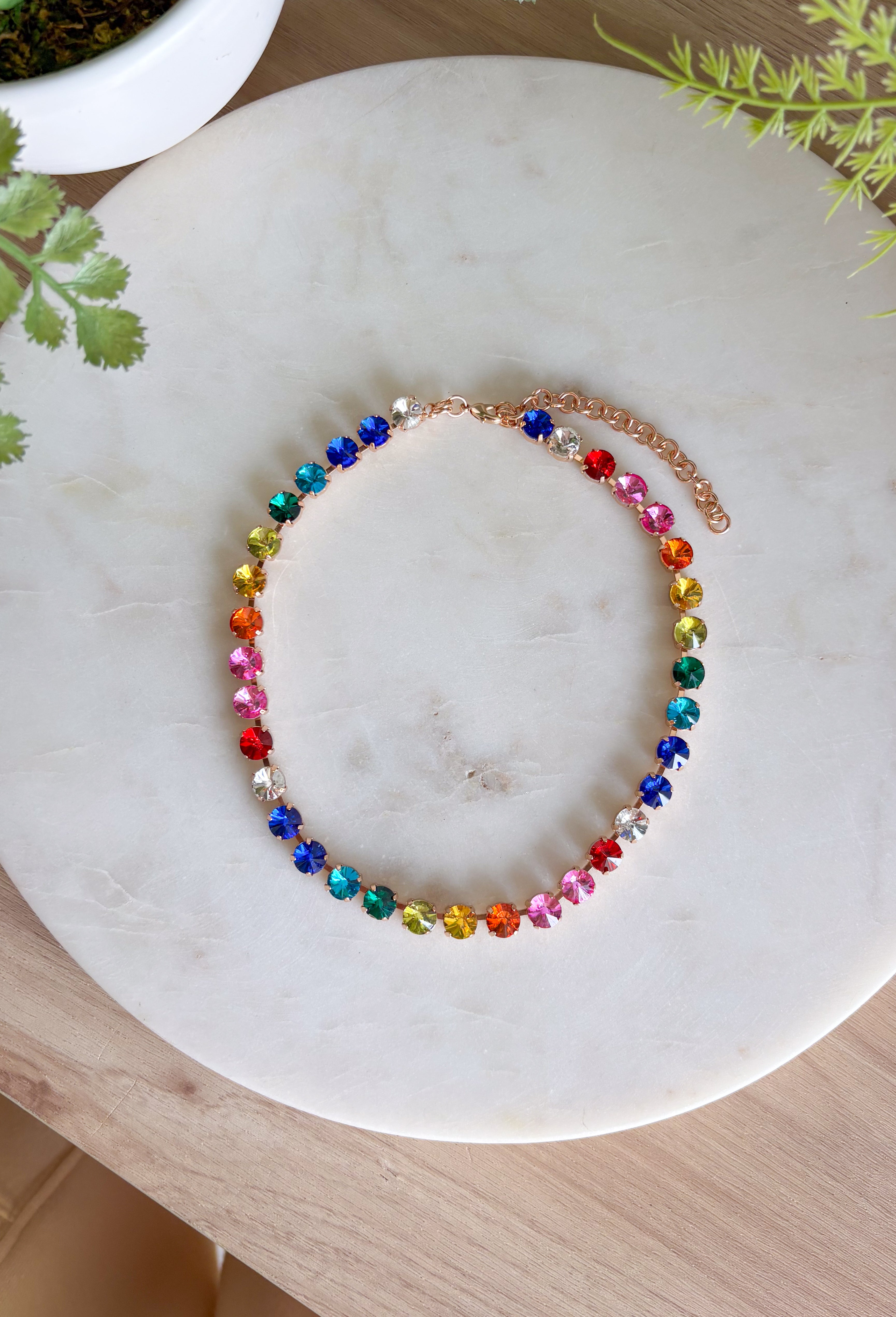 This vibrant rainbow gemstone necklace is pure spring joy in accessory form. Featuring faceted crystal stones in bold, playful colors, each gem is set in a warm gold setting that adds just the right touch of polish. The mix of colors makes it an instant outfit-lifter—perfect for adding personality to everyday looks or finishing off a fun spring outfit. Wear it solo as a statement or layer it with your favorite gold chains for an easy, colorful moment.