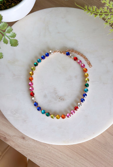 This vibrant rainbow gemstone necklace is pure spring joy in accessory form. Featuring faceted crystal stones in bold, playful colors, each gem is set in a warm gold setting that adds just the right touch of polish. The mix of colors makes it an instant outfit-lifter—perfect for adding personality to everyday looks or finishing off a fun spring outfit. Wear it solo as a statement or layer it with your favorite gold chains for an easy, colorful moment.